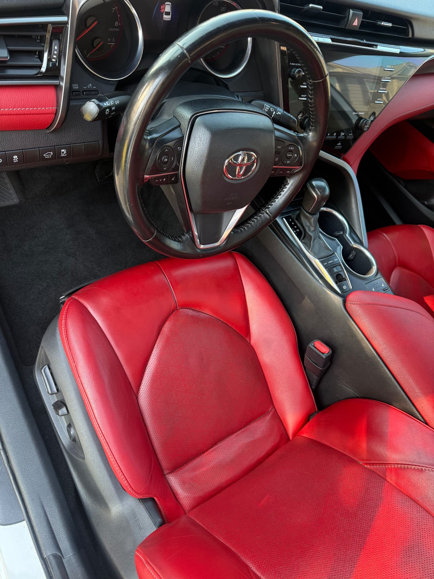 Detailed Toyota Camry driver seat, red leather and steering wheel after Miller's Detailing interior detail in Atlanta